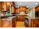Cozy kitchen with wooden cabinetry, granite countertops, kitchen island, and modern appliances at 205 Camden Creek Ct, Lawrenceville, GA 30043