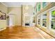 Bright living room featuring soaring ceilings, fireplace, large windows and hardwood floors at 205 Camden Creek Ct, Lawrenceville, GA 30043
