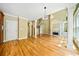 Bright living room featuring hardwood floors, elegant columns, fireplace, and access to kitchen at 205 Camden Creek Ct, Lawrenceville, GA 30043