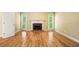 Bright living room with hardwood floors, fireplace, and natural light from large windows at 205 Camden Creek Ct, Lawrenceville, GA 30043