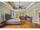 Spacious primary bedroom featuring tray ceilings, hardwood floors, and a serene atmosphere at 205 Camden Creek Ct, Lawrenceville, GA 30043