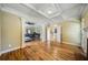 View of the open layout bedroom, hardwood floors and fireplace beyond at 205 Camden Creek Ct, Lawrenceville, GA 30043