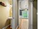 View from powder room to a dining area with hardwood floors, chandelier, and a large window at 205 Camden Creek Ct, Lawrenceville, GA 30043
