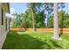 Spacious backyard with lush artificial turf and a playset, enclosed by a wooden fence at 2297 Nesbitt Ne Dr, Brookhaven, GA 30319
