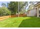Expansive backyard with lush artificial turf and a wooden fence, offering privacy and space at 2297 Nesbitt Ne Dr, Brookhaven, GA 30319
