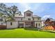 Spacious backyard with a covered patio, playset, and lush green lawn at 2297 Nesbitt Ne Dr, Brookhaven, GA 30319