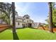Large backyard featuring a playground and a covered patio, surrounded by a wooden fence at 2297 Nesbitt Ne Dr, Brookhaven, GA 30319