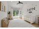Bright Bedroom with a crib, zebra art, and a giraffe toy offers a cozy space for baby at 2297 Nesbitt Ne Dr, Brookhaven, GA 30319