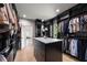 Spacious walk-in closet boasts custom organizers, a center island with marble countertop, and natural light from window at 2297 Nesbitt Ne Dr, Brookhaven, GA 30319