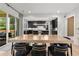 Open-concept dining area with modern lighting, a large table, and views into the kitchen at 2297 Nesbitt Ne Dr, Brookhaven, GA 30319