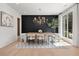 Modern dining room featuring a unique table, designer chandelier, and views from the large windows at 2297 Nesbitt Ne Dr, Brookhaven, GA 30319