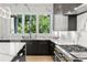 Modern kitchen with marble countertops, stainless steel appliances, and view of the greenery at 2297 Nesbitt Ne Dr, Brookhaven, GA 30319