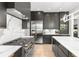 Modern kitchen featuring stainless steel appliances, marble countertops and backsplash, and ample cabinet space at 2297 Nesbitt Ne Dr, Brookhaven, GA 30319