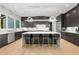 Modern kitchen features a large island, stainless steel appliances, and stylish black cabinetry at 2297 Nesbitt Ne Dr, Brookhaven, GA 30319