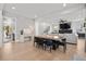 Open-concept living area with a dining table, fireplace, and views of the staircase at 2297 Nesbitt Ne Dr, Brookhaven, GA 30319