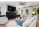 Spacious living room featuring a modern fireplace, comfortable seating, and a stylish ceiling fan at 2297 Nesbitt Ne Dr, Brookhaven, GA 30319