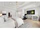 Large main bedroom featuring a tray ceiling, hardwood floors, and access to the main bath at 2297 Nesbitt Ne Dr, Brookhaven, GA 30319