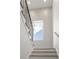 Bright staircase with wooden steps, black railing, white walls and a window with decorative moulding detail at 2297 Nesbitt Ne Dr, Brookhaven, GA 30319