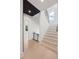 Bright staircase with hardwood floors, black railings, and decorative wood paneled ceiling at 2297 Nesbitt Ne Dr, Brookhaven, GA 30319