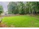Expansive backyard with a well-kept lawn, mature trees, and a wooden privacy fence at 4271 Brighton Nw Way, Kennesaw, GA 30144