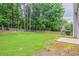 Spacious backyard with a lawn, mature trees, patio area, and wooden privacy fence at 4271 Brighton Nw Way, Kennesaw, GA 30144