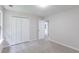 Bedroom with light walls, carpet, and a closet with sliding doors at 4271 Brighton Nw Way, Kennesaw, GA 30144
