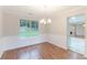 Elegant dining room with hardwood floors, a chandelier, and a large window at 4271 Brighton Nw Way, Kennesaw, GA 30144