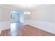The dining room features elegant trim, a modern chandelier, and beautiful wood floors at 4271 Brighton Nw Way, Kennesaw, GA 30144