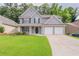 Charming gray two-story home with a well-manicured lawn and a two-car garage at 4271 Brighton Nw Way, Kennesaw, GA 30144