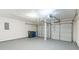 Two-car garage with painted floors, overhead door and trash recepticles at 4271 Brighton Nw Way, Kennesaw, GA 30144