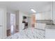 Bright kitchen with stainless steel appliances, white cabinets, and marble floors at 4271 Brighton Nw Way, Kennesaw, GA 30144