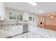 Open kitchen with white cabinets, stainless steel appliances, and marble floors at 4271 Brighton Nw Way, Kennesaw, GA 30144