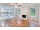 Open-concept living room featuring a fireplace, hardwood floors, and natural light at 4271 Brighton Nw Way, Kennesaw, GA 30144