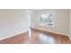 Bright living room with hardwood floors, wainscoting and large window at 4271 Brighton Nw Way, Kennesaw, GA 30144