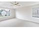 Spacious bedroom with neutral walls, carpet, and tray ceiling with fan at 4271 Brighton Nw Way, Kennesaw, GA 30144