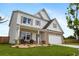 Attractive two-story home with stone accents, a welcoming front porch, and professionally landscaped front yard at 437 Autrey Dr, Douglasville, GA 30134