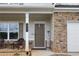 Inviting front porch with stone accents, a cozy seating area, and a welcoming entrance at 437 Autrey Dr, Douglasville, GA 30134