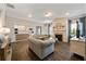 Bright, open living room with fireplace, sofas, wood floors and view to kitchen at 437 Autrey Dr, Douglasville, GA 30134