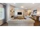 Spacious living room with a fireplace, wood floors, and comfortable light-grey sofas at 437 Autrey Dr, Douglasville, GA 30134