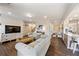 Open-concept living room with wood floors, light-grey sofas, and access to kitchen at 437 Autrey Dr, Douglasville, GA 30134