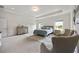 Spacious main bedroom featuring a tray ceiling, soft carpet, two windows, and comfortable chairs at 437 Autrey Dr, Douglasville, GA 30134