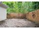 Brick patio in backyard surrounded by lush trees, perfect for outdoor activities at 4594 Poplar Rd, Pine Lake, GA 30072