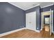 Well lit bedroom with hardwood floors and white trim. Closet space is easily accesible at 4594 Poplar Rd, Pine Lake, GA 30072