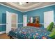 Stylish bedroom showcases a large bed with colorful bedding and wooden furniture at 4594 Poplar Rd, Pine Lake, GA 30072