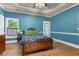 Charming bedroom features beautiful blue walls, wood flooring, and natural light at 4594 Poplar Rd, Pine Lake, GA 30072