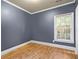 Clean bedroom features wood flooring, neutral walls, and plenty of natural light at 4594 Poplar Rd, Pine Lake, GA 30072