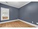 Inviting bedroom showcases hardwood floors, neutral paint, and large window at 4594 Poplar Rd, Pine Lake, GA 30072