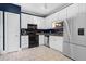 Modern kitchen with white cabinets, stainless steel appliances, and granite countertops at 4594 Poplar Rd, Pine Lake, GA 30072