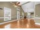 Spacious living room with hardwood floors, ceiling fans, and large windows providing ample natural light at 4594 Poplar Rd, Pine Lake, GA 30072