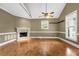 Spacious living room with hardwood floors, fireplace, and large windows offering ample natural light at 4594 Poplar Rd, Pine Lake, GA 30072